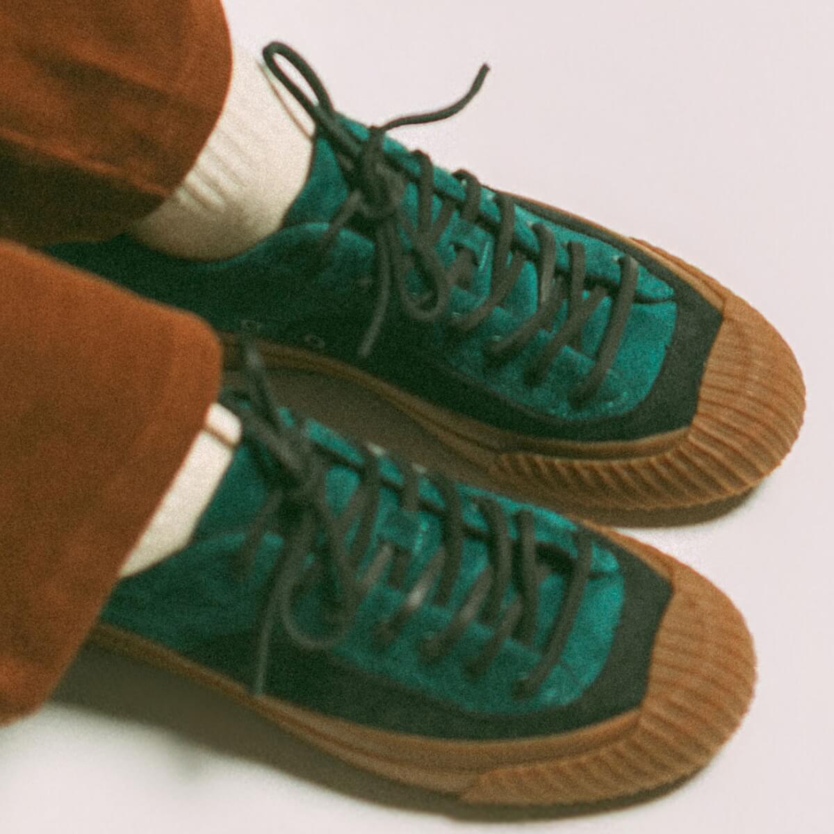 Green and gum low-top sneakers on a white background