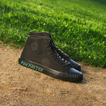 Black high-top sneakers with 'Run Faster' text on a grassy and dirt path background