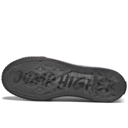 Black sole of a sneaker on a white background, with “Jump Higher” printed on the sole.