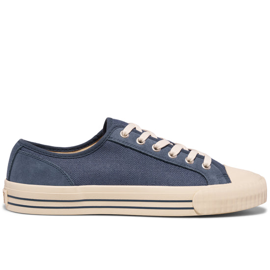 Blue low-top sneaker with white laces on a white background.