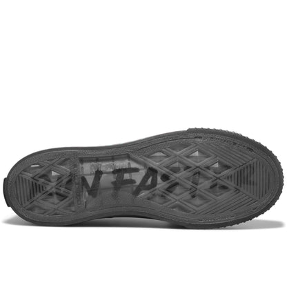 Black sole of a sneaker on a white background, with “Run Faster” printed on the sole.