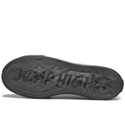 Black sole of a sneaker on a white background, with “Jump Higher” printed on the sole.