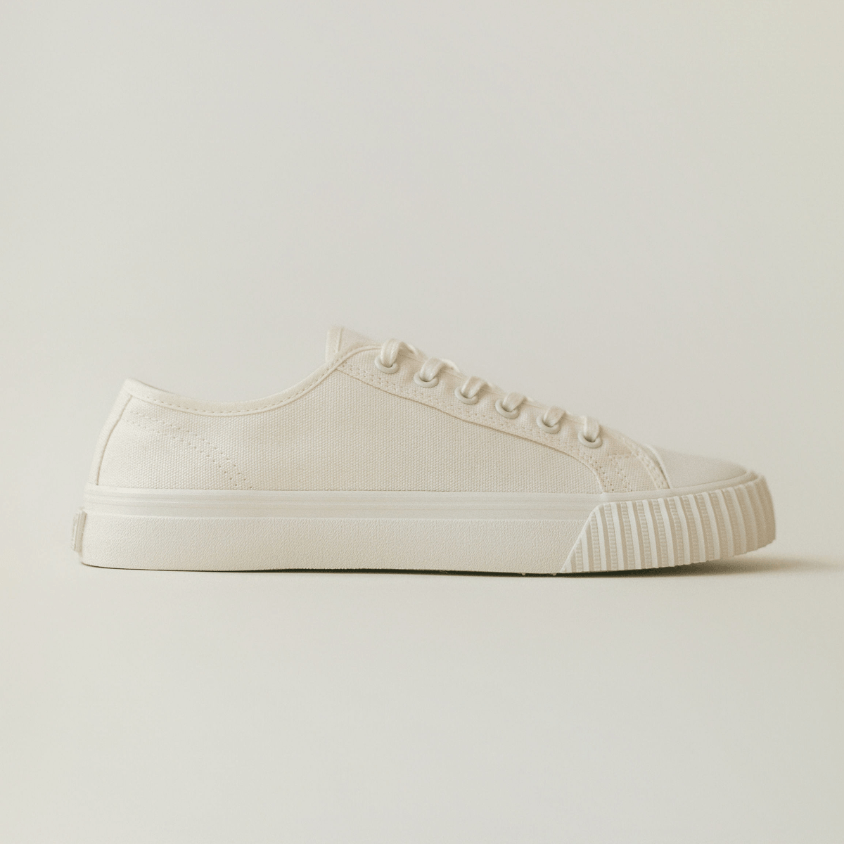 White low-top sneaker on a light background.