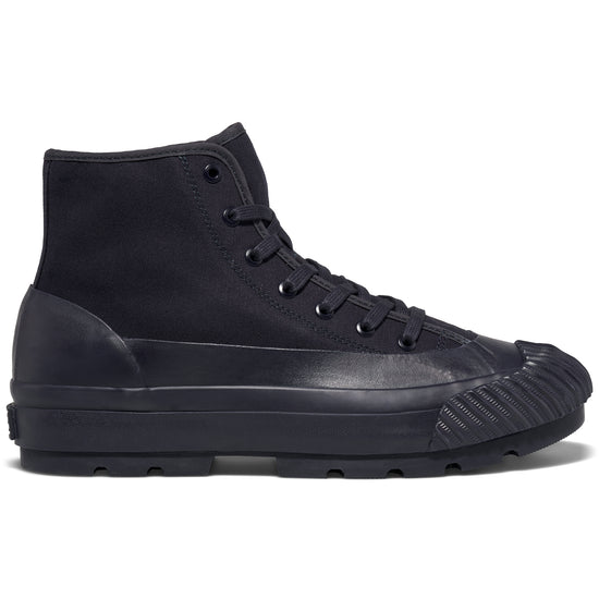 A navy high-top sneaker with a lugged rubber outsole shown on a white background.