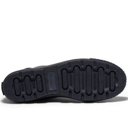 View of a shoe's navy rubber outsole set against a plain white background.