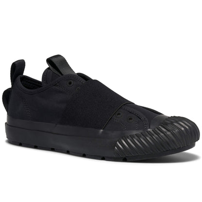 Black slip-on sneaker with a textured sole on a white background