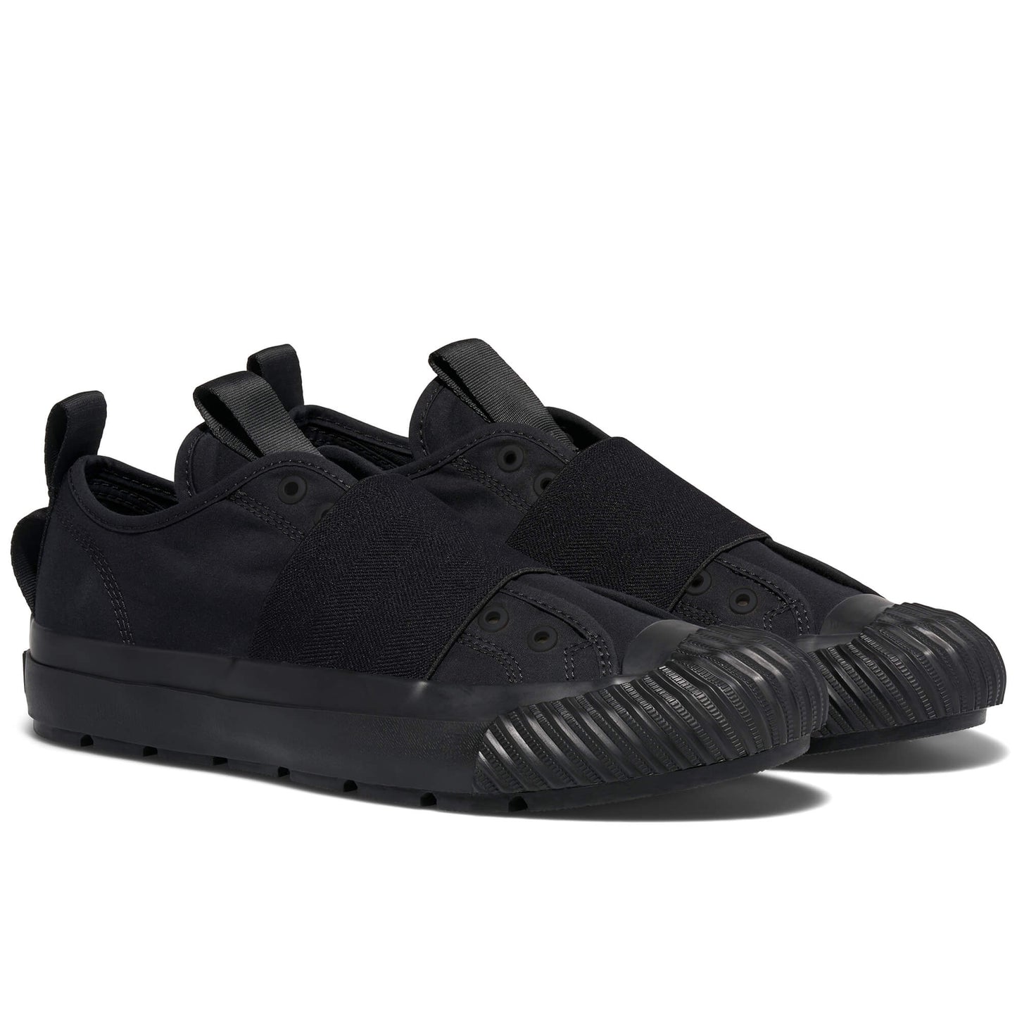 Black slip-on sneakers on a white background