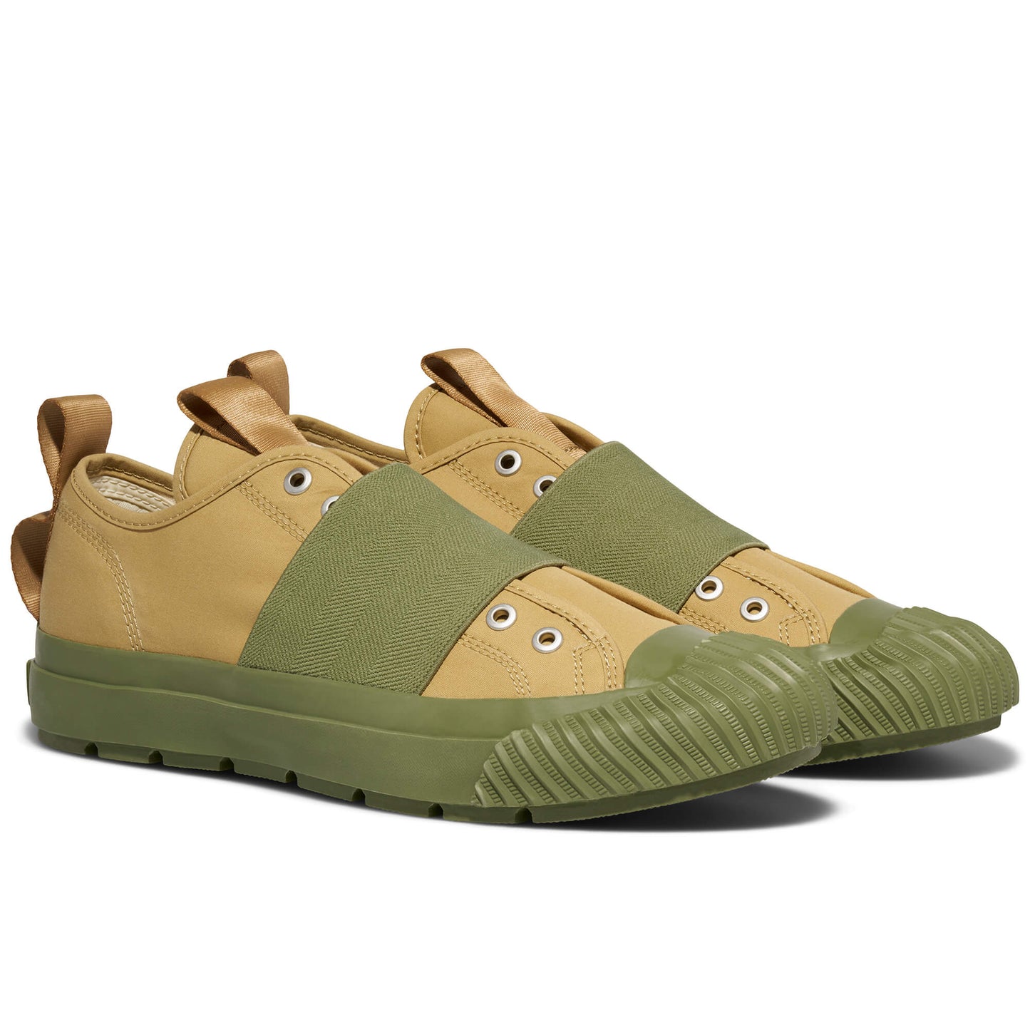 Pair of tan and green sneakers on a white background
