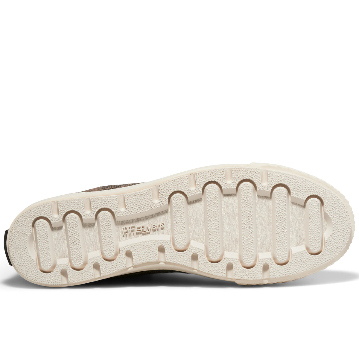 A shoe's off-white rubber outsole set against a plain white background.