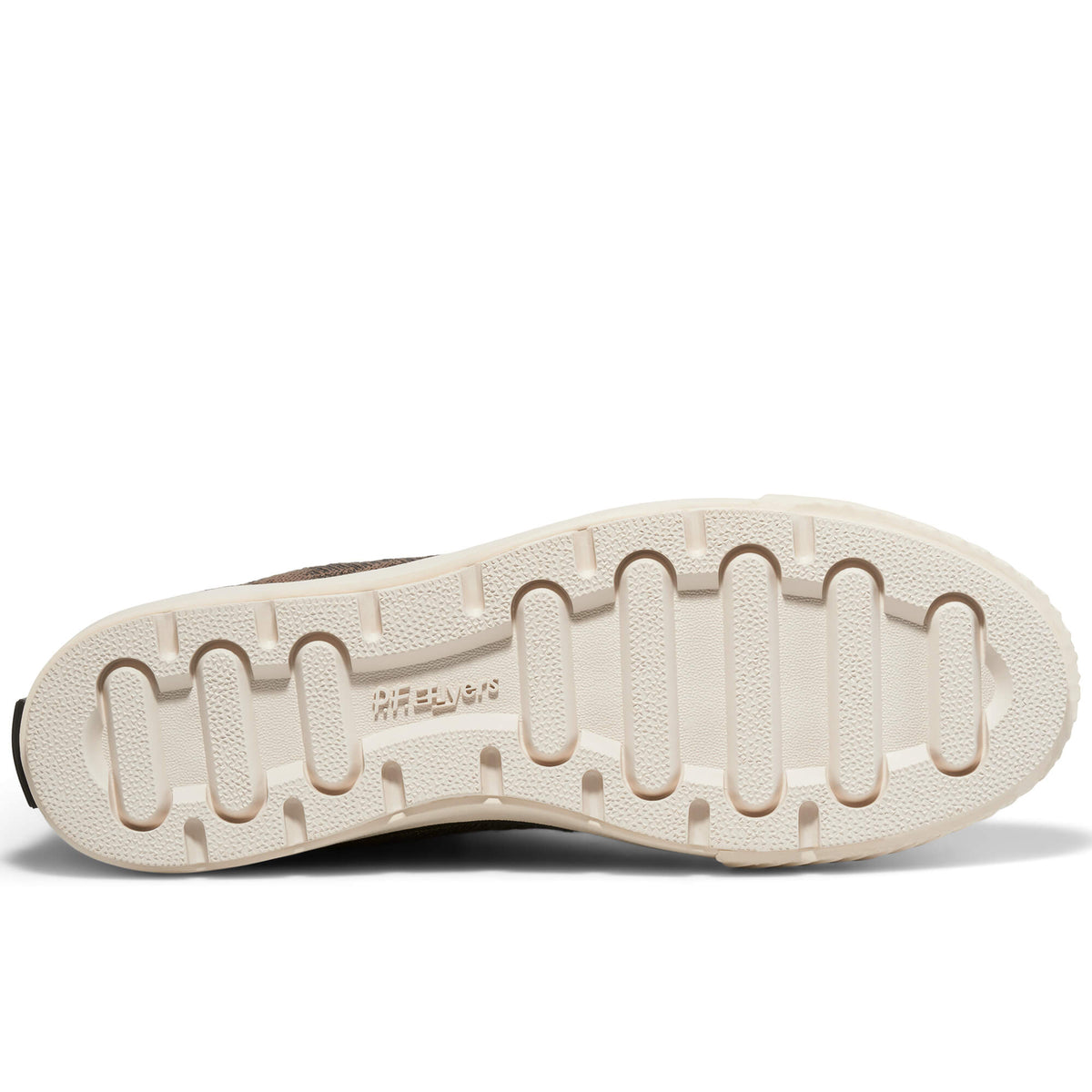A shoe's off-white rubber outsole set against a plain white background.