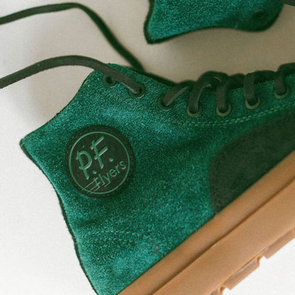 Green suede shoe with 'P.F. Flyers' logo on a white background
