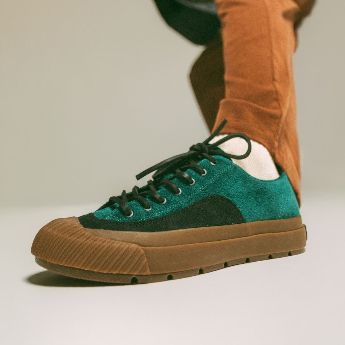 Green and gum sneaker on a neutral background