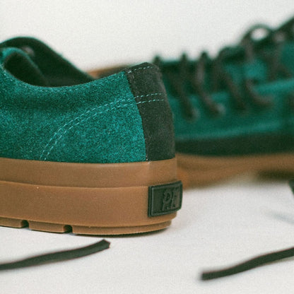 Green and gum sneakers with a P.F. brand logo on a white background