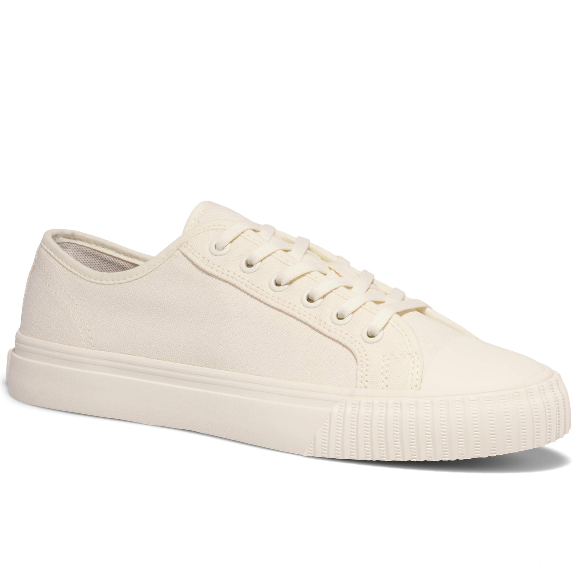 White low-top canvas sneakers on a white background.